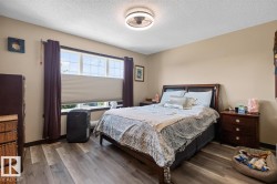 Spacious room featuring wood-finish flooring and neutral wall tones - 