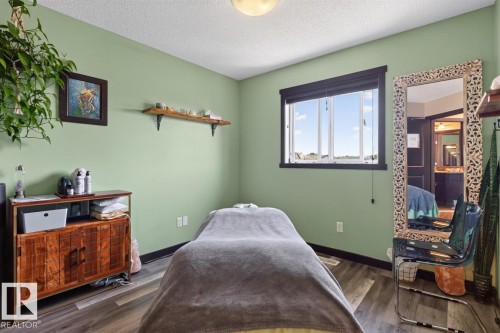 Bedroom with light green walls and wood-finish flooring - 3627 12 Street Nw, Edmonton, AB - Indoor Photo Showing Bedroom