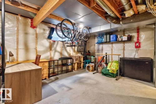 Unfinished lower level featuring exposed wood beams, concrete flooring, insulated walls, and visible ductwork - 3627 12 Street Nw, Edmonton, AB - Indoor Photo Showing Basement