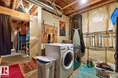 Dedicated laundry area featuring a front-loading washing machine and dryer, exposed ceiling joists, and concrete flooring - 3627 12 Street Nw, Edmonton, AB - Indoor Photo Showing Laundry Room