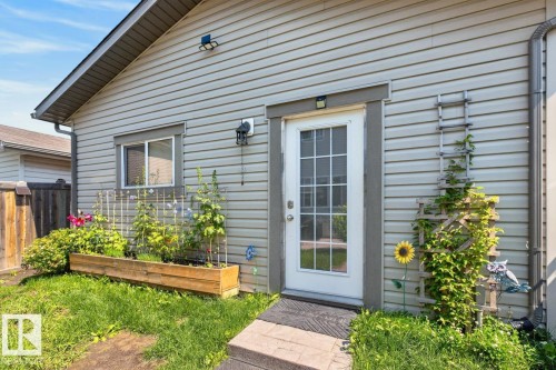 Vinyl-sided exterior featuring a glass-paned door with white trim - 3627 12 Street Nw, Edmonton, AB - Outdoor With Exterior