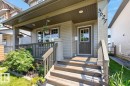 Inviting front porch with wood-finish stairs and railings, offering a covered entry - 3627 12 Street Nw, Edmonton, AB  - Outdoor With Deck Patio Veranda With Exterior 