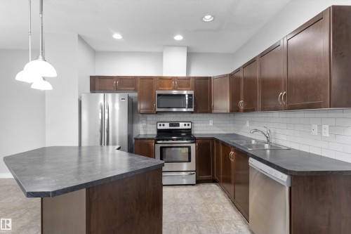 #7 13825 155 Av Nw, Edmonton, AB - Indoor Photo Showing Kitchen With Double Sink