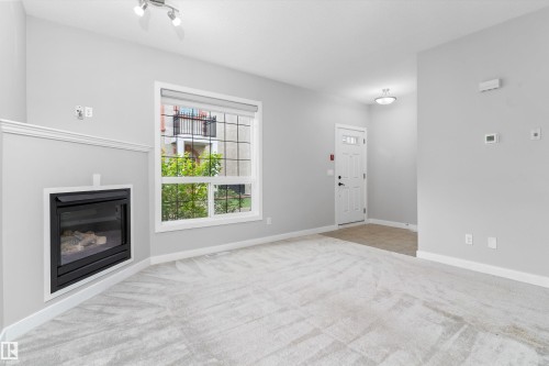 #7 13825 155 Av Nw, Edmonton, AB - Indoor Photo Showing Other Room With Fireplace