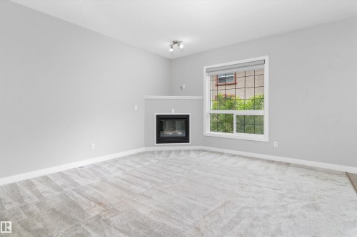 #7 13825 155 Av Nw, Edmonton, AB - Indoor Photo Showing Living Room With Fireplace