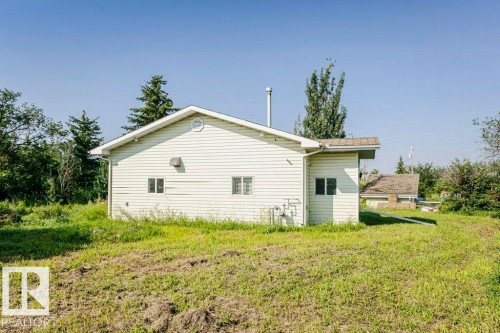 Vinyl siding exterior featuring multiple windows and a prominent gable vent - 55319 Rge Road 222, Rural Sturgeon County, AB 