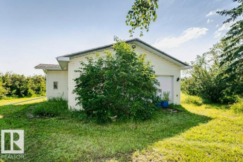 Detached structure featuring white siding and a sloped roofline - 55319 Rge Road 222, Rural Sturgeon County, AB 