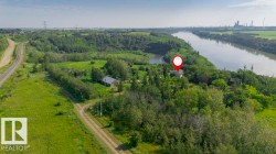 Property situated on a riverfront parcel with surrounding mature trees and extensive green space - 