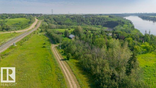 Expansive green landscape featuring a prominent river, dense wooded areas, and a visible railway line - 55319 Rge Road 222, Rural Sturgeon County, AB 