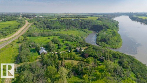 Expansive property featuring a riverfront setting with established trees and lush green landscapes - 55319 Rge Road 222, Rural Sturgeon County, AB 