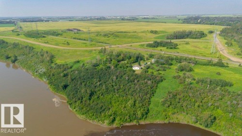 Rural property with extensive surrounding greenery, bordering a substantial body of water - 55319 Rge Road 222, Rural Sturgeon County, AB 