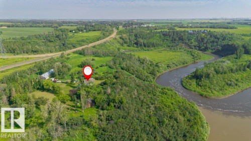 Expansive rural property featuring a winding river, mature trees, open green spaces, and a nearby roadway - 55319 Rge Road 222, Rural Sturgeon County, AB 