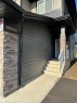 Exterior facade featuring horizontal siding and stacked stone accents - #2 2710 66 St Sw, Edmonton, AB  - Outdoor With Exterior 