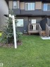 Rear exterior featuring horizontal siding in a dark tone with lighter accent panels - #2 2710 66 St Sw, Edmonton, AB  - Outdoor With Deck Patio Veranda 
