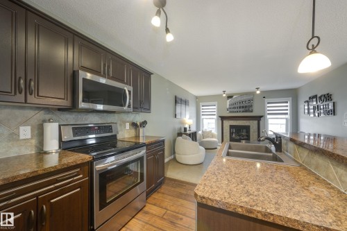 5881 168A Avenue Nw, Edmonton, AB - Indoor Photo Showing Kitchen With Fireplace With Double Sink