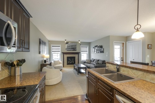 5881 168A Avenue Nw, Edmonton, AB - Indoor Photo Showing Kitchen With Fireplace With Double Sink