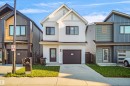 Contemporary two-story residence featuring a white vertical siding facade - #42 19904 31 Av Nw, Edmonton, AB  - Outdoor With Facade 
