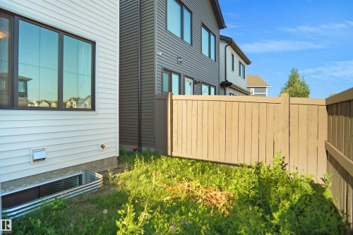 White horizontal siding with dark window frames - #42 19904 31 Av Nw, Edmonton, AB - Outdoor With Exterior