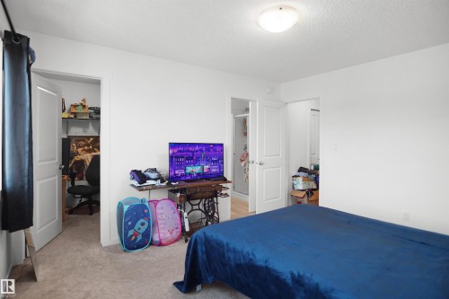 Room featuring neutral carpet flooring, white walls, and a ceiling-mounted light fixture - #42 19904 31 Av Nw, Edmonton, AB - Indoor Photo Showing Bedroom