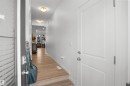 Bright hallway featuring wood-finish flooring, recessed ceiling lights, and light-toned wall paint - #42 19904 31 Av Nw, Edmonton, AB  - Indoor Photo Showing Other Room 