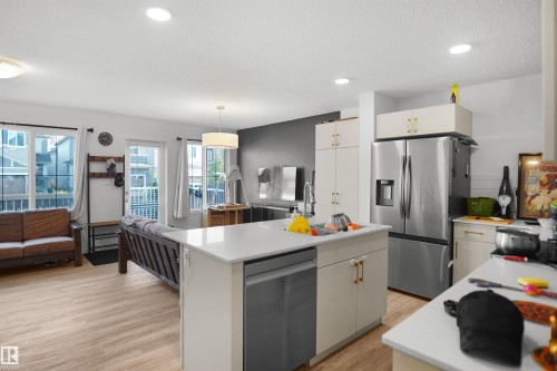 Open-concept living space with light wood-finish flooring - #42 19904 31 Av Nw, Edmonton, AB - Indoor Photo Showing Kitchen