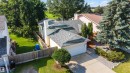 Two-story residence featuring a gray shingle roof, white exterior siding, and an attached garage with a white door - 4639 10 Avenue Nw, Edmonton, AB  - Outdoor 