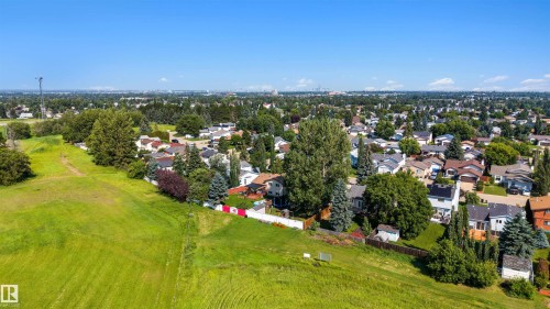 Expansive green space bordering a residential neighborhood, featuring mature trees and established homes - 4639 10 Avenue Nw, Edmonton, AB - Outdoor With View