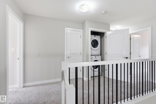 Second-story hallway featuring light gray walls, plush gray carpeting, and white trim - 1860 Keene Crescent Sw, Edmonton, AB - Indoor Photo Showing Other Room