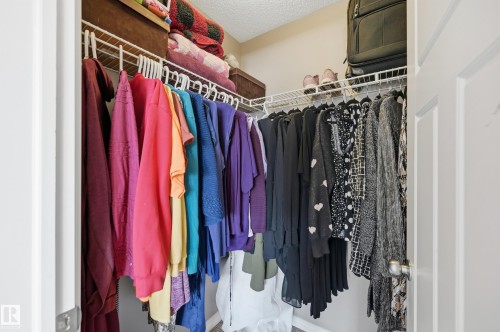 Built-in closet system featuring white wire shelving and hanging rods - 3606 Whitelaw Bay Nw, Edmonton, AB - Indoor With Storage