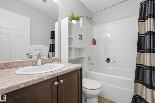 Bathroom featuring a vanity with a light-toned countertop, a white oval sink, and a chrome faucet - 3606 Whitelaw Bay Nw, Edmonton, AB - Indoor Photo Showing Bathroom