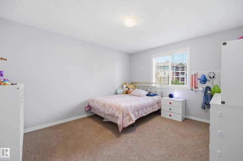 Windowed room featuring textured carpeting, neutral wall paint, and white trim - 3606 Whitelaw Bay Nw, Edmonton, AB - Indoor Photo Showing Bedroom