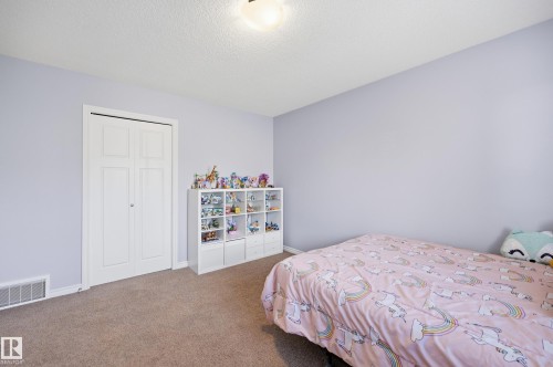 Carpeted room with a bi-fold closet, white baseboards, and light-toned walls - 3606 Whitelaw Bay Nw, Edmonton, AB - Indoor Photo Showing Bedroom