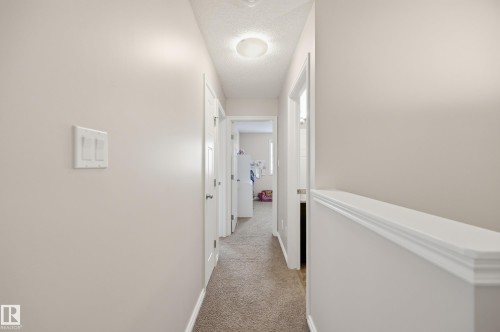 Hallway featuring neutral wall paint, white trim, textured ceiling, and recessed lighting - 3606 Whitelaw Bay Nw, Edmonton, AB - Indoor Photo Showing Other Room