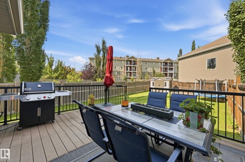 Spacious outdoor deck featuring wood-finish flooring and black metal railings - 3606 Whitelaw Bay Nw, Edmonton, AB - Outdoor With Deck Patio Veranda With Exterior