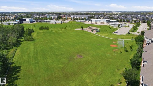 Expansive open green space featuring a baseball diamond, playground, and paved walking paths - 3606 Whitelaw Bay Nw, Edmonton, AB - Outdoor With View