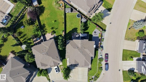 Aerial perspective showcasing residential properties with gray shingle roofs, green lawns, and established trees - 3606 Whitelaw Bay Nw, Edmonton, AB - Outdoor With View