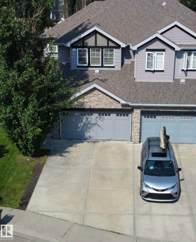 Two-story residential exterior featuring gray siding and a shingled roof - 3606 Whitelaw Bay Nw, Edmonton, AB - Outdoor