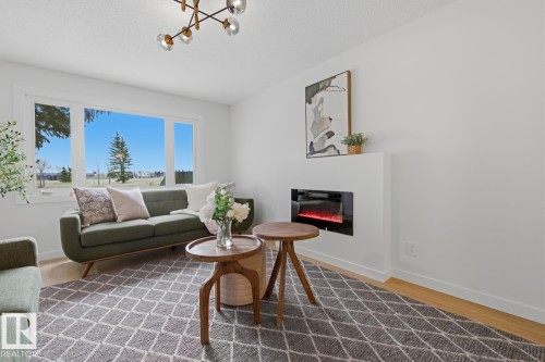 7D Callingwood Court Nw, Edmonton, AB - Indoor Photo Showing Living Room With Fireplace