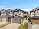 Two-story residence featuring a multi-toned exterior, an attached garage, and a concrete driveway - 4003 39 Street, Beaumont, AB  - Outdoor With Facade 