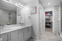 Double vanity with white cabinetry and integrated sinks - 