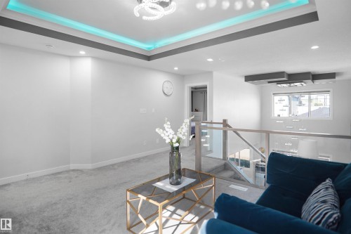 Upper-level living area with recessed lighting and a contemporary light fixture - 4003 39 Street, Beaumont, AB - Indoor Photo Showing Other Room
