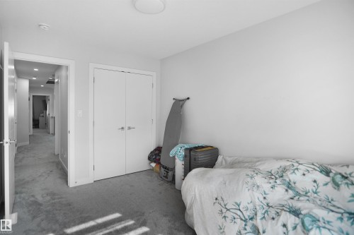 Recessed lighting illuminates a hallway featuring light gray walls and plush gray carpeting - 4003 39 Street, Beaumont, AB - Indoor Photo Showing Bedroom