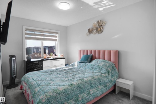 Bright room with a large window featuring horizontal blinds - 4003 39 Street, Beaumont, AB - Indoor Photo Showing Bedroom