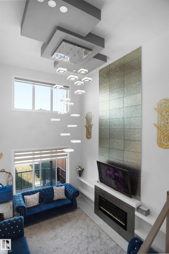 Two-story open-concept living area featuring a contemporary tiered ceiling with recessed lighting and a multi-level chandelier - 4003 39 Street, Beaumont, AB - Indoor