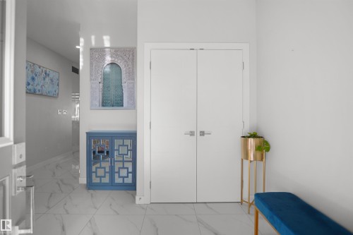 Entryway featuring large format marble-look tile flooring and clean white walls - 4003 39 Street, Beaumont, AB - Indoor Photo Showing Other Room