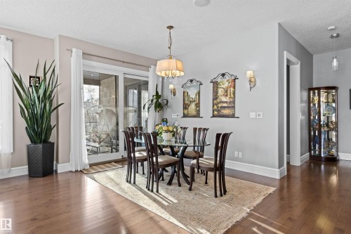 Dining space with dark wood-style flooring and a textured ceiling - 2796 Wheaton Drive Nw, Edmonton, AB - Indoor Photo Showing Dining Room