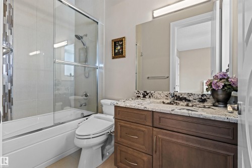 Full bath with vanity and shower / bath combination with glass door - 2796 Wheaton Drive Nw, Edmonton, AB - Indoor Photo Showing Bathroom