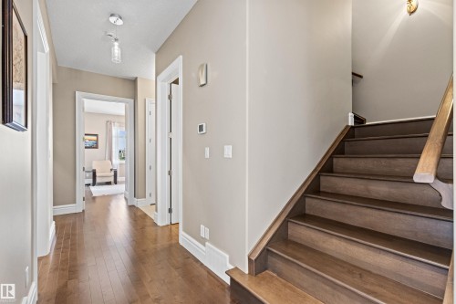 Stairs featuring wood-type flooring and a textured ceiling - 2796 Wheaton Drive Nw, Edmonton, AB - Indoor Photo Showing Other Room