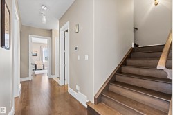 Stairs featuring wood-type flooring and a textured ceiling - 