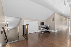 Office area featuring a textured ceiling, dark wood-style floors, and vaulted ceiling - 